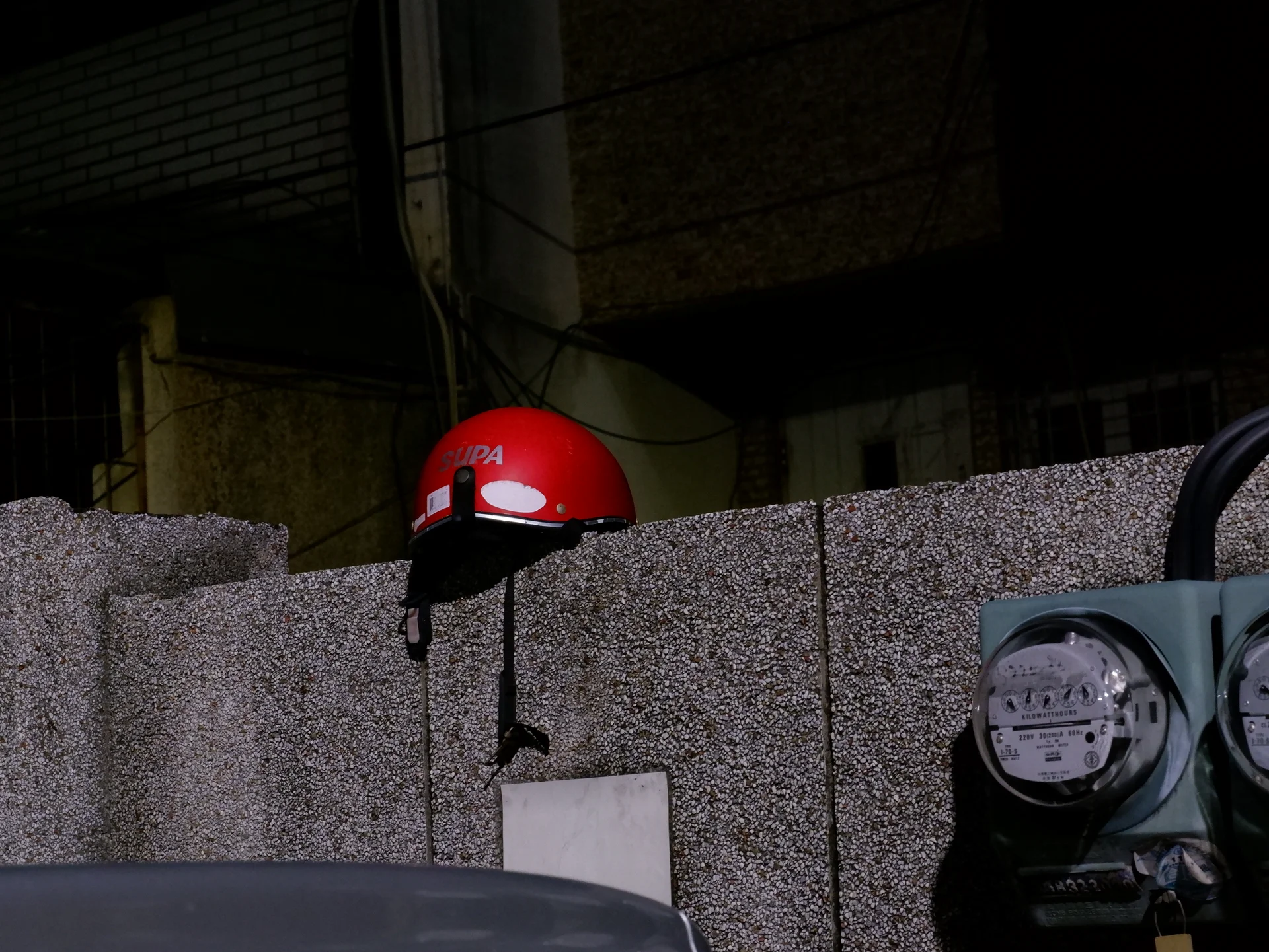 A red helmet above a wall