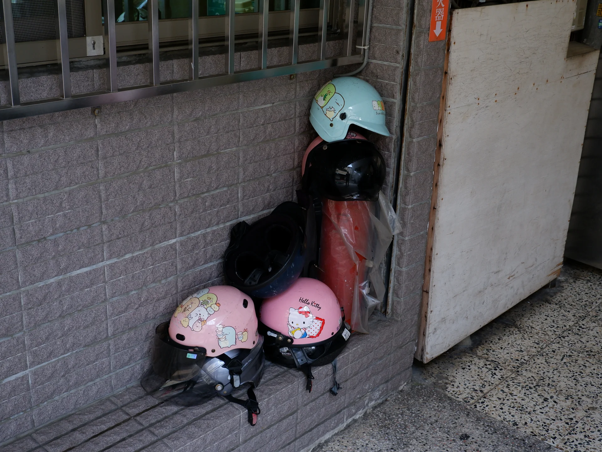A cluster of pastel helmets by a doorway