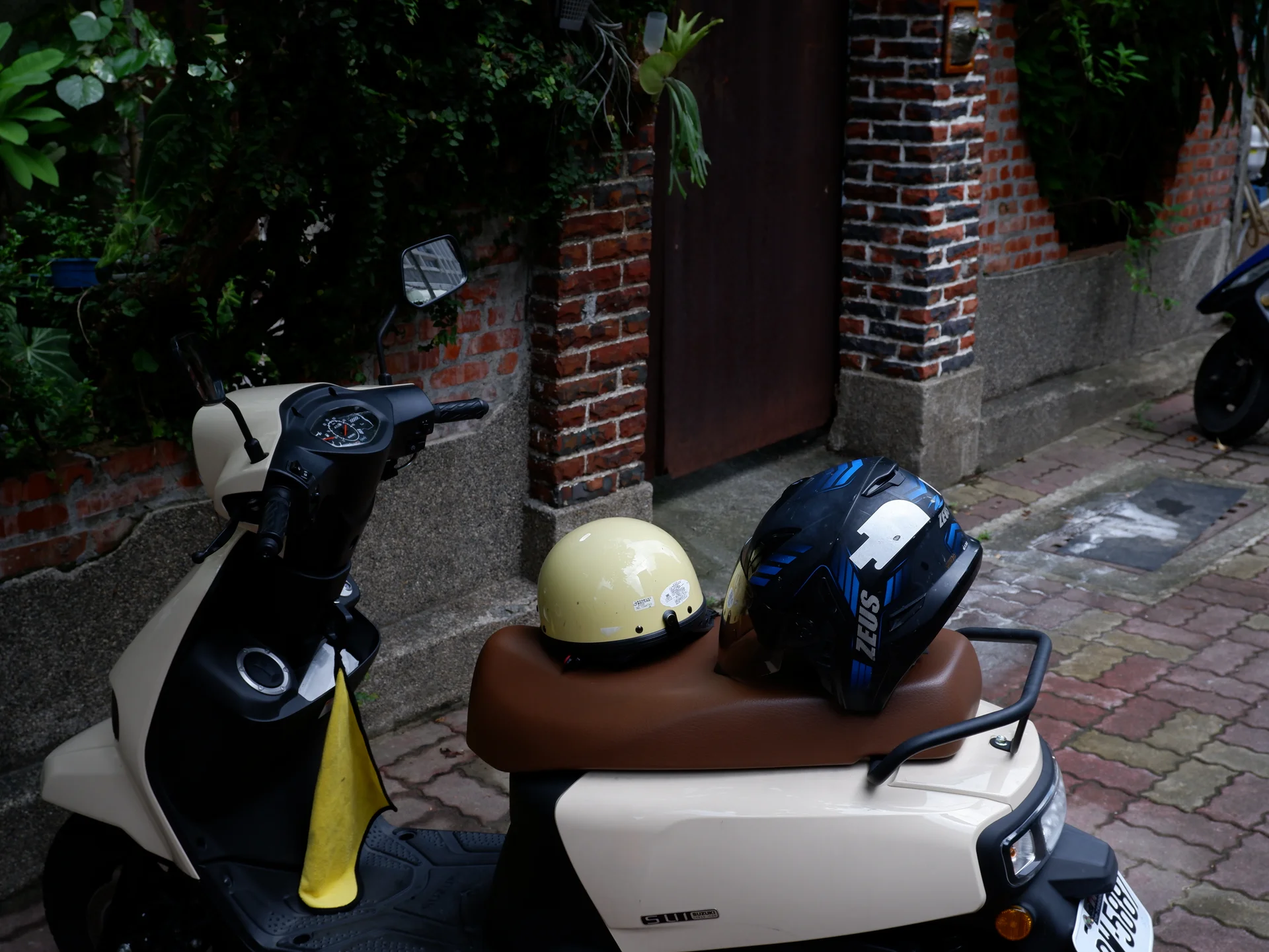 Two helmets resting on a scooter