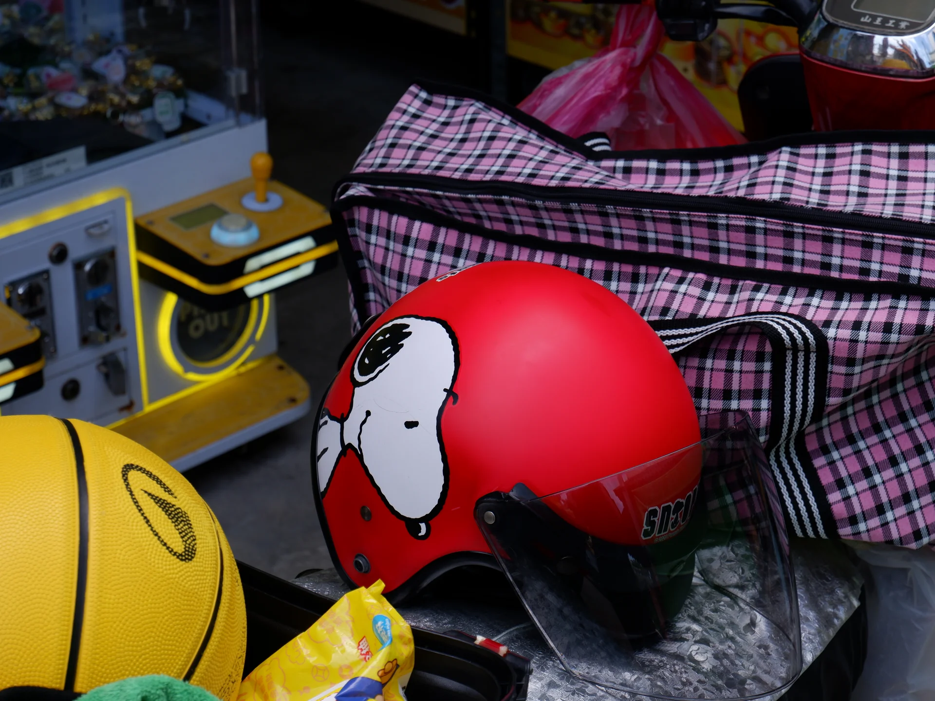 A red character helmet on a scooter