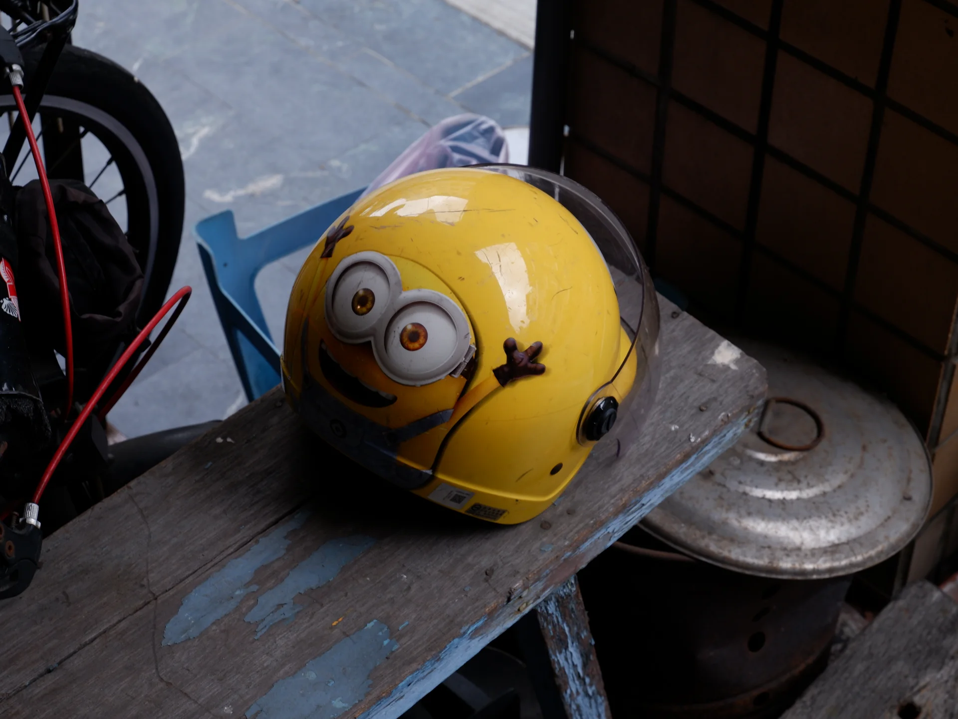 A yellow illustrated helmet on a scooter