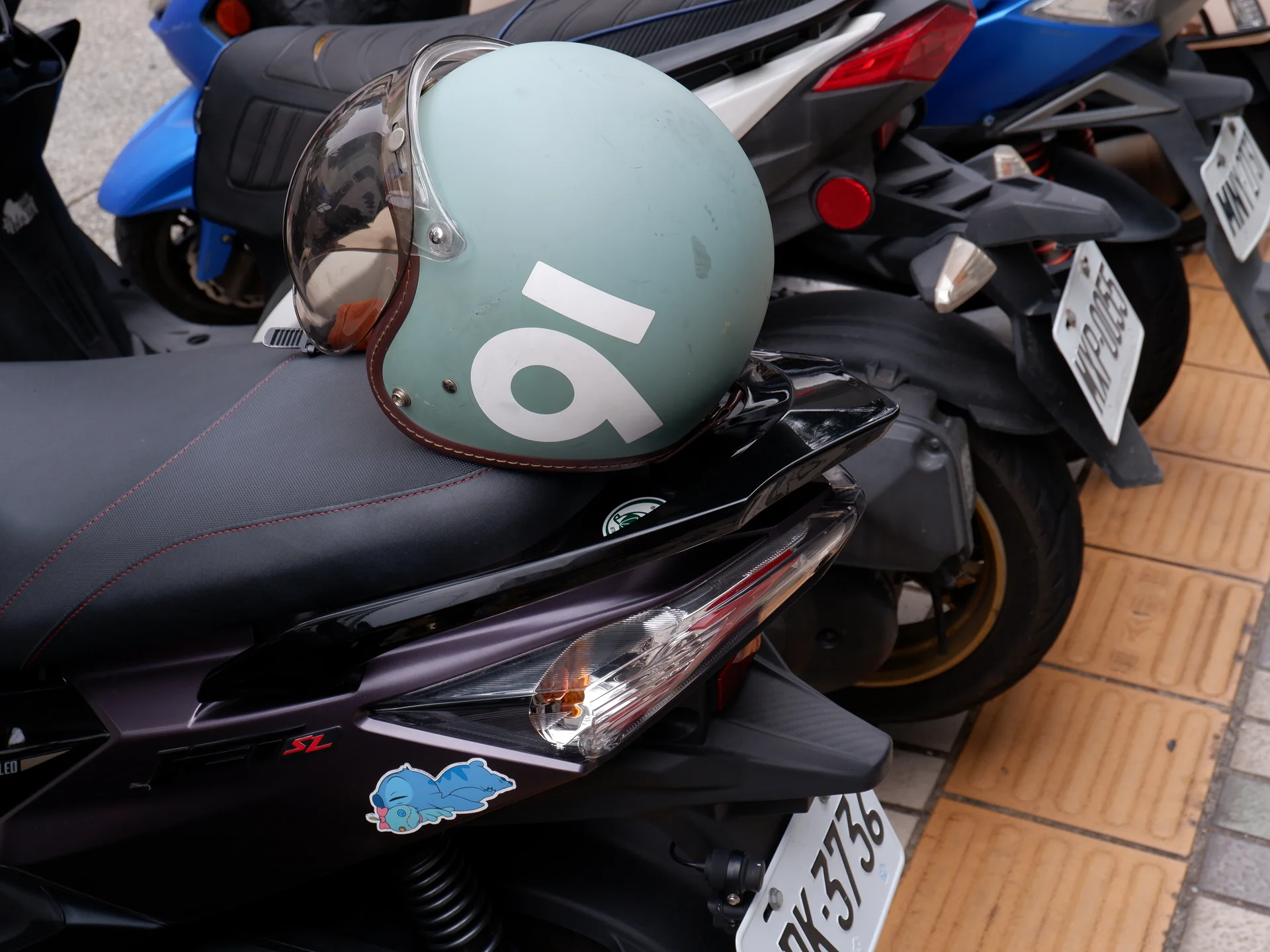 A green helmet on a scooter seat